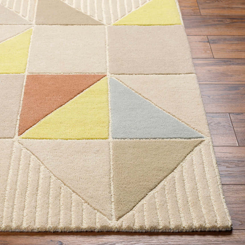 Close-up of the Mani Area Rug; a hand-tufted wool rug with a geometric pattern in camel, beige, gray, and yellow tones. Front