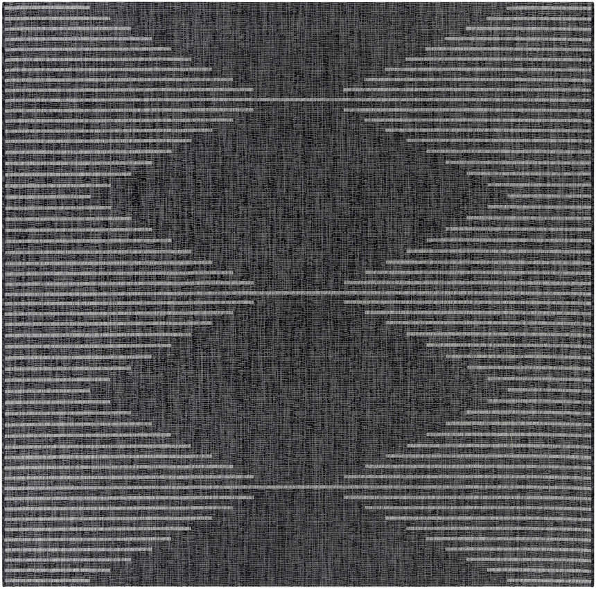 Close-up of the Stephan Area Rug; a black rug with a geometric pattern of cream and light gray horizontal lines. Design-Square-710