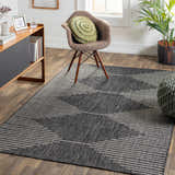 Living room scene with a black and cream Stephan Area Rug, wood floors, and mid-century modern furniture. Roomscene-Rectangle