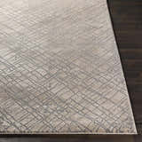 Close-up of the Strykersville Area Rug. Beige rug with a charcoal geometric pattern on a dark wood floor. Front