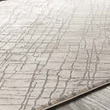 Close-up of the Strykersville Area Rug showing its beige color and charcoal grid pattern. Machine woven texture. Texture