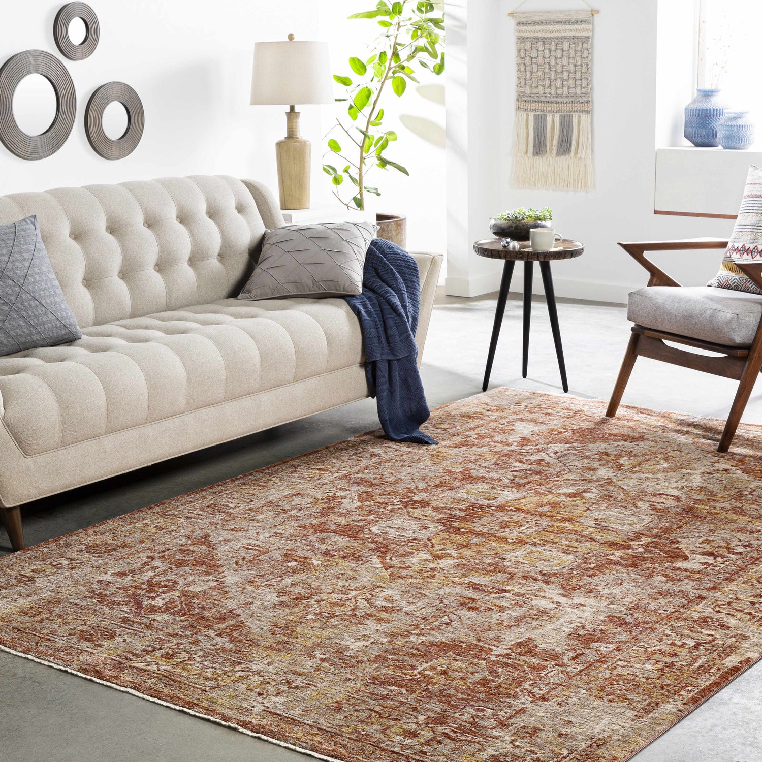 Living room with a Strathbogie Traditional Red Area Rug, beige sofa, and mid-century modern chair. Earthy, warm tones. Roomscene-Rectangle