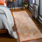 Bedroom scene with Strathbogie Traditional Red Area Rug. Rug has brick red, cream, and mustard colors. Bohemian style. Roomscene-Runner