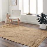 Living room scene with a natural jute Zeno Area Rug, white chair, side table, and dark wood floors. Roomscene-Rectangle