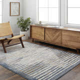 Living room scene with a gray and smoke Kylar Area Rug, wooden chair, and mid-century modern cabinet. Roomscene-Rectangle