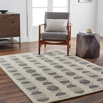 Living room scene with a Matt Area Rug in taupe and gray with a geometric circle pattern. Roomscene-Rectangle