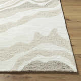Close-up of the Siani Beige Wool Area Rug showing its textured, hand-tufted wool and wavy pattern in ash, silver gray, and white. Front
