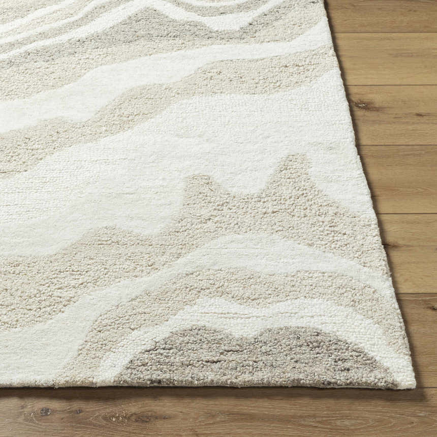 Close-up of the Siani Beige Wool Area Rug showing its textured, hand-tufted wool and wavy pattern in ash, silver gray, and white. Front