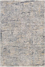 Close-up of the Sywell Luxe Fringe Rug. Contemporary design in beige, blue, charcoal, and tan hues. Machine woven texture. Design-Rectangle-6796