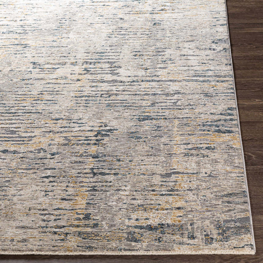 Close-up of the Sywell Luxe Fringe Rug. Beige, blue, and charcoal abstract pattern. Contemporary style. Front
