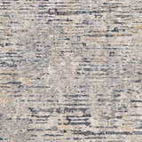 Close-up of the Sywell Luxe Fringe Rug. Beige, blue, charcoal, and tan abstract pattern. Machine woven polyester rug. Swatch