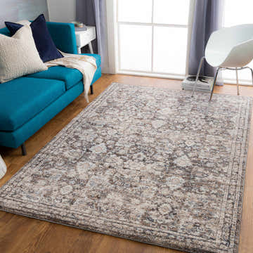 Living room scene with a Talihina Brown Luxe Damask Rug, teal sofa, white chair, and wood floors. Roomscene-Rectangle