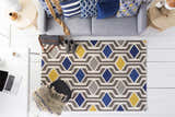 Modern living room scene with a Taneytown rug featuring a geometric diamond pattern in charcoal, cream, mustard, and navy. Roomscene-Rectangle