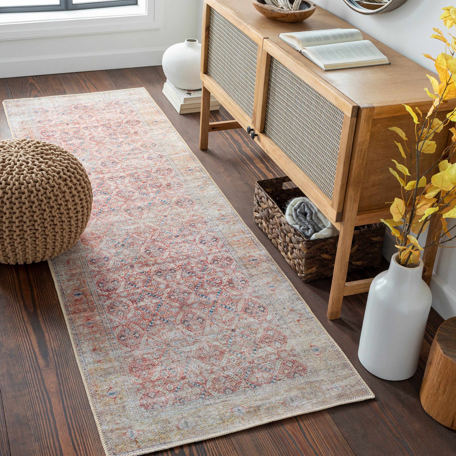 Entryway scene with a Brick Red Tapia Washable Area Rug runner, wood console table, pouf, and dark wood floors. Roomscene-Runner