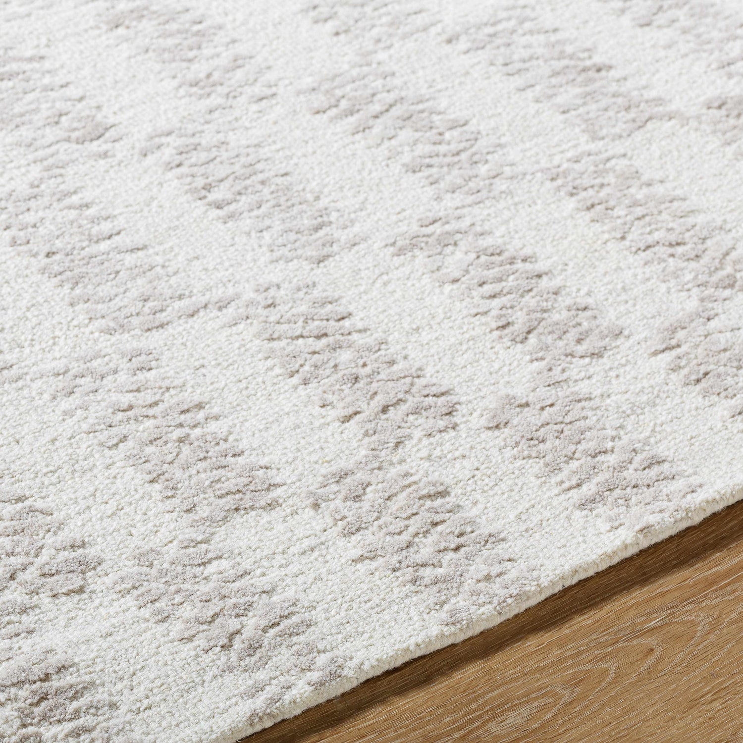 Close up of Theda Area Rug showing the ash and off white contemporary pattern and wool texture. Texture