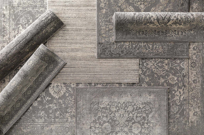 Close-up of the Watford Updated Traditional Tibetan Rug in charcoal, gray, ivory, and tan with a vintage floral pattern. Styleshot