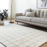 Living room scene with a neutral sofa and the Tanya Pearl White Grid Wool Rug. Roomscene-Rectangle