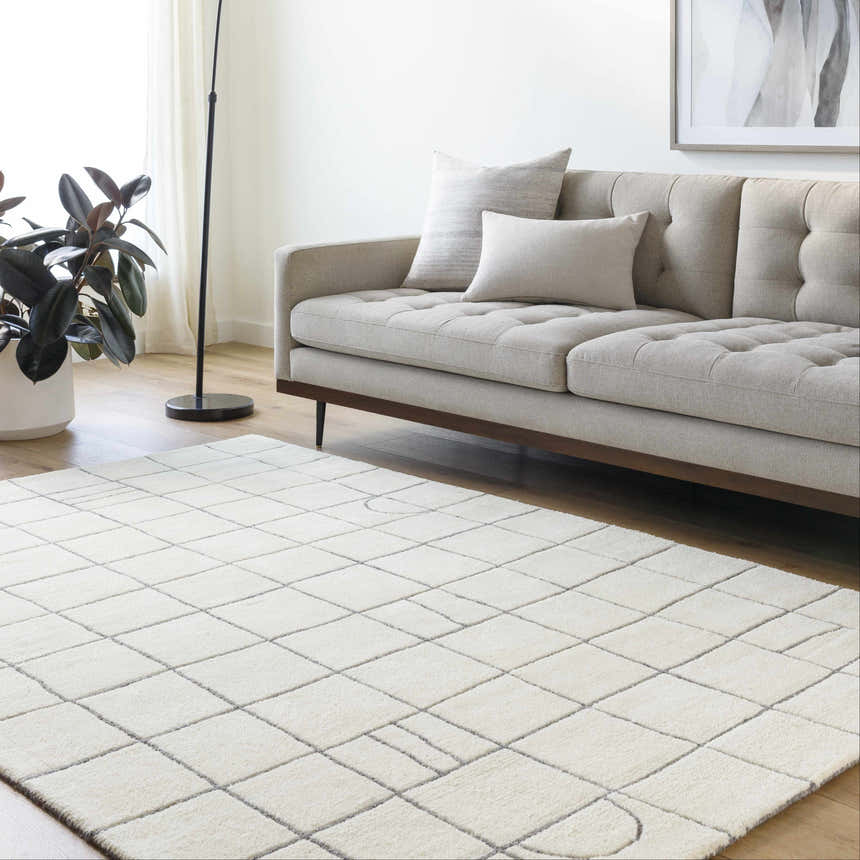 Living room scene with a neutral sofa and the Tanya Pearl White Grid Wool Rug. Roomscene-Rectangle