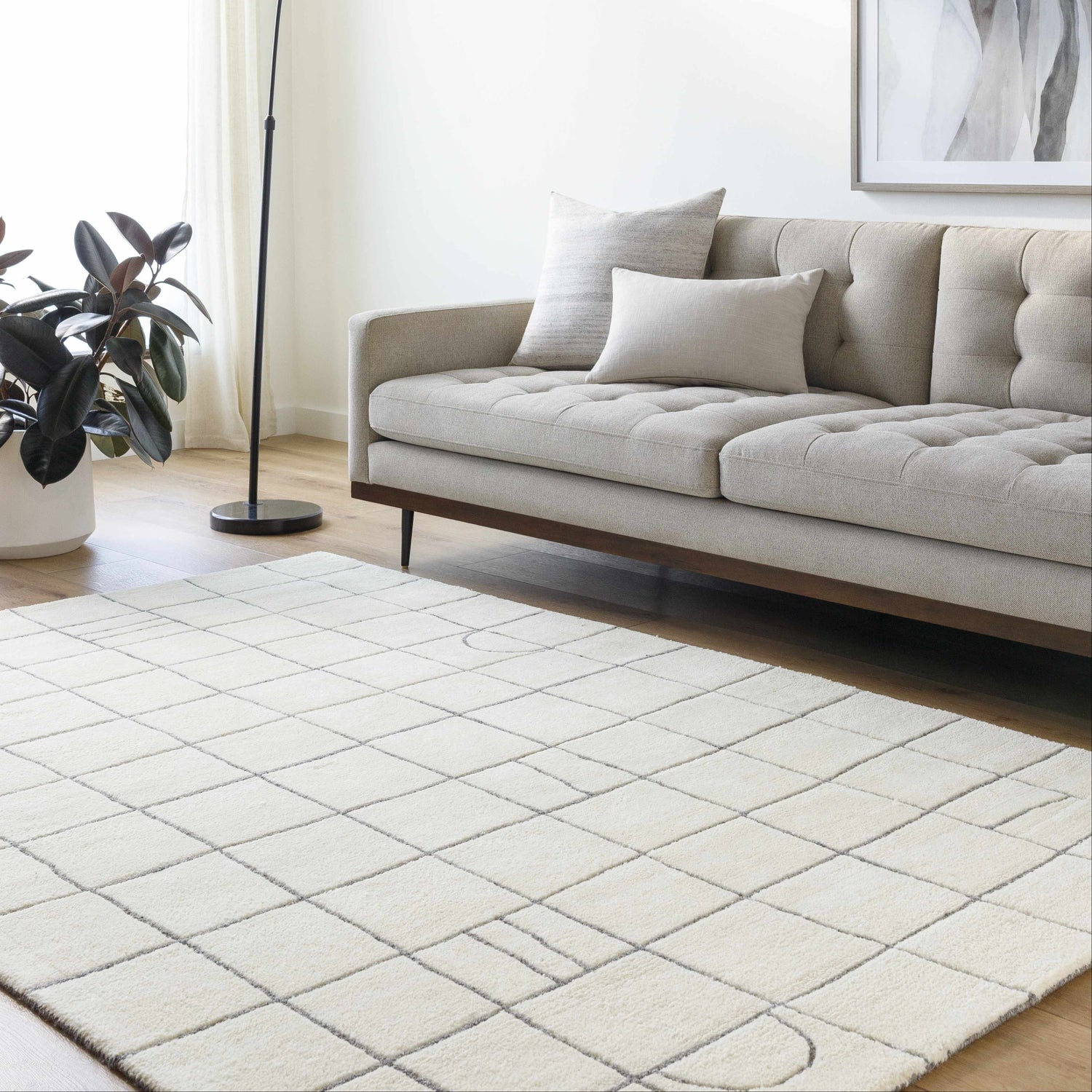 Living room scene with a neutral sofa and the Tanya Pearl White Grid Wool Rug. Roomscene-Rectangle