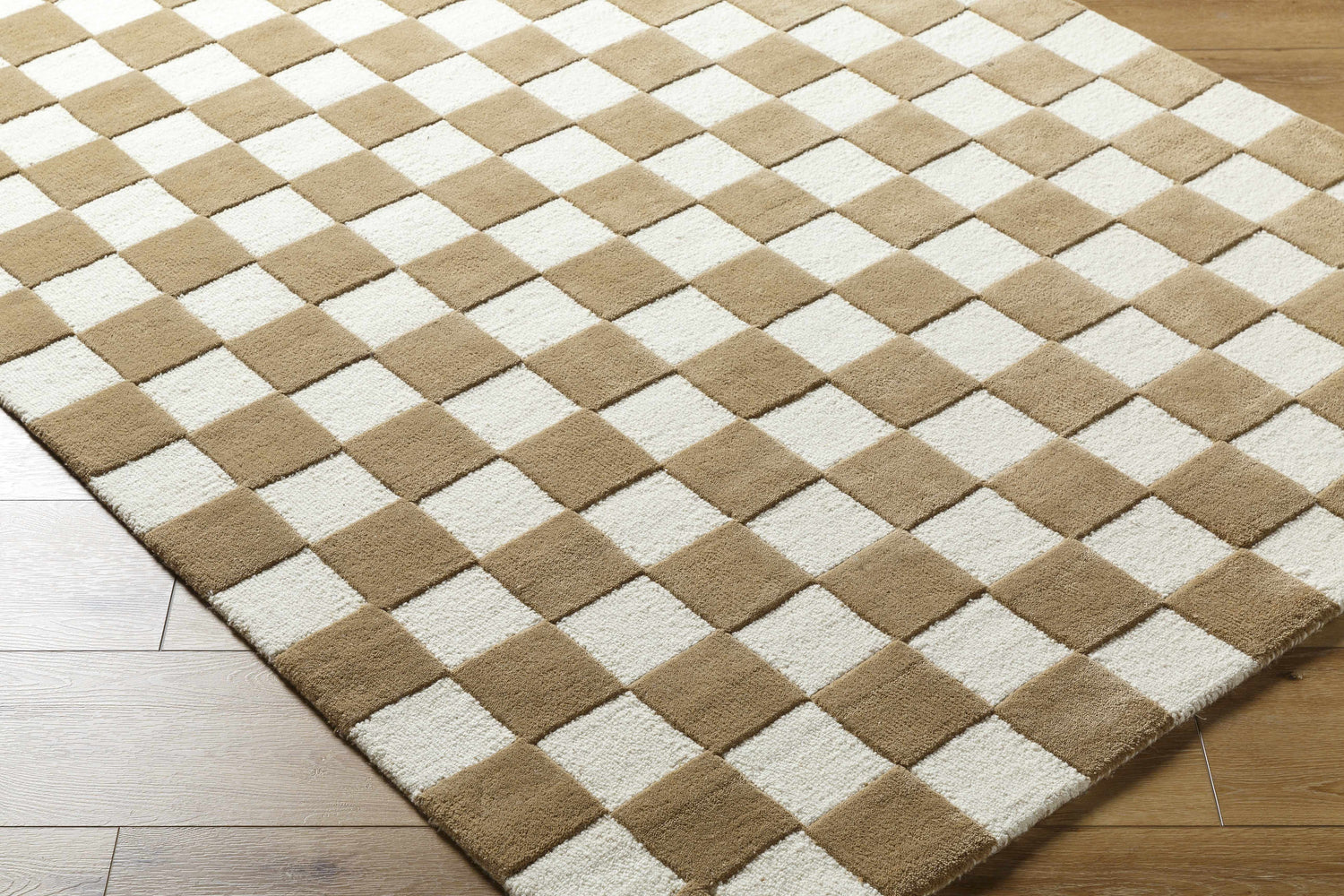 Close-up of the Timin Brown Checkered Wool Area Carpet. Cream and brown checkerboard pattern, hand-tufted texture. Corner