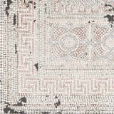 Close-up of the Terlingua Area Rug, featuring a beige, black, and pastel red geometric pattern. Bohemian style. Swatch