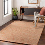 Living room scene with Teresita Area Rug in burnt orange and ivory, wood floors, console table, and chair. Roomscene-Rectangle