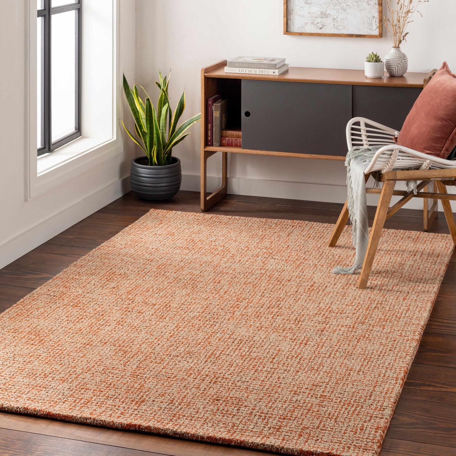 Living room scene with Teresita Area Rug in burnt orange and ivory, wood floors, console table, and chair. Roomscene-Rectangle