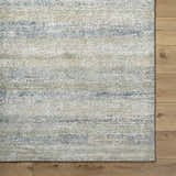Close-up of Taran Thick Luxe Rug showing light gray, olive, peach, and tan hues with a soft, textured pile. Corner