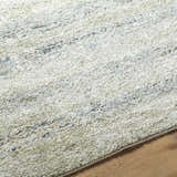 Close up of Taran Thick Luxe Rug showing light gray, olive, peach, and tan tones and plush texture. Texture
