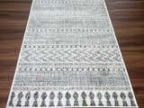 Close-up of the Tigri Aztec Ivory & Gray 2311 Rug showing its gray and ivory bohemian pattern and machine-made texture. Front