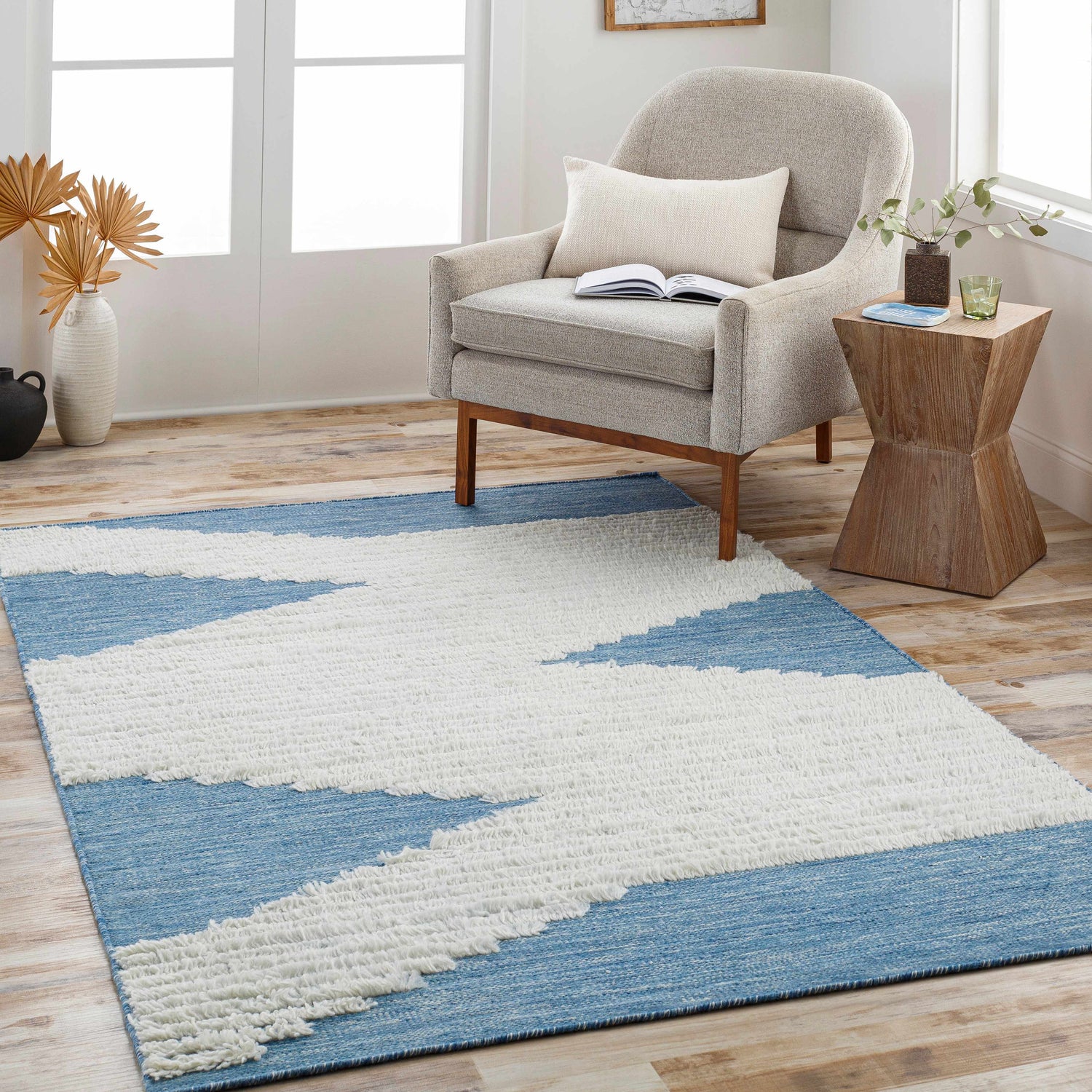 Living room scene with bright blue and cream Thika Area Rug, accent chair, and side table. Roomscene-Rectangle