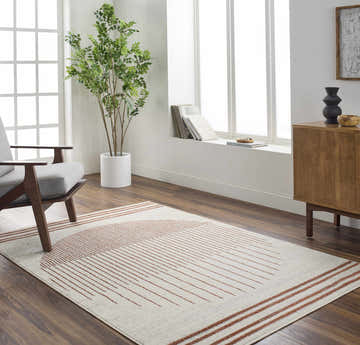 Bright living room with a Thono Area Rug, gray chair, wood cabinet, and large window. Roomscene-Rectangle