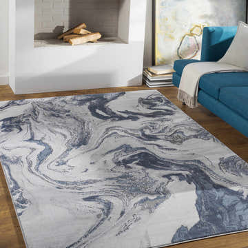 Living room scene with a Moana Denim Blue Marble area rug, blue sofa, and white fireplace. Roomscene-Rectangle