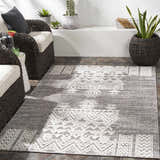 Outdoor patio scene with gray wicker furniture and the Thorntonville outdoor rug in gray and white. Roomscene-Rectangle