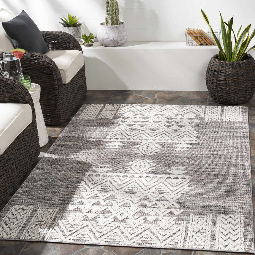 Outdoor patio scene with gray wicker furniture and the Thorntonville outdoor rug in gray and white. Roomscene-Rectangle