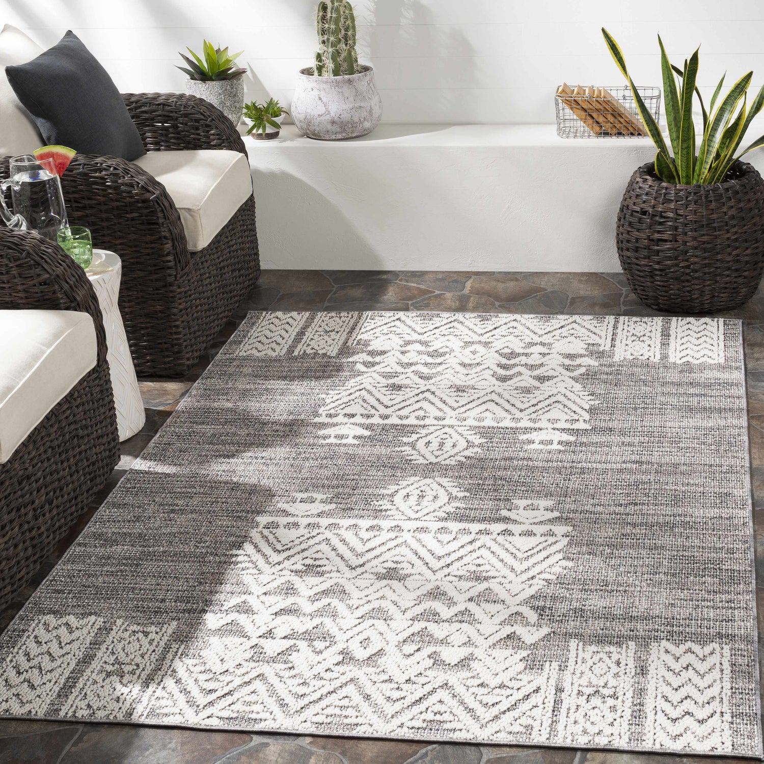 Outdoor patio scene with gray wicker furniture and the Thorntonville outdoor rug in gray and white. Roomscene-Rectangle
