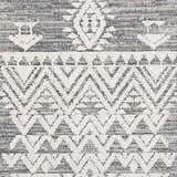 Close-up of Thorntonville Outdoor Rug showing its gray and white bohemian geometric pattern and jute texture. Swatch