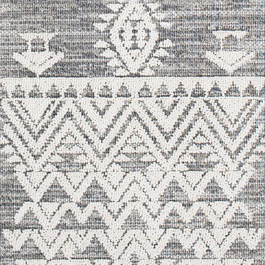 Close-up of Thorntonville Outdoor Rug showing its gray and white bohemian geometric pattern and jute texture. Swatch