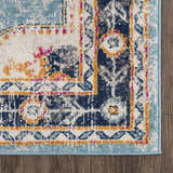 Close-up of the Tigried Turquoise 2308 rug, showcasing its blue, ivory, and orange bohemian-style pattern. Corner