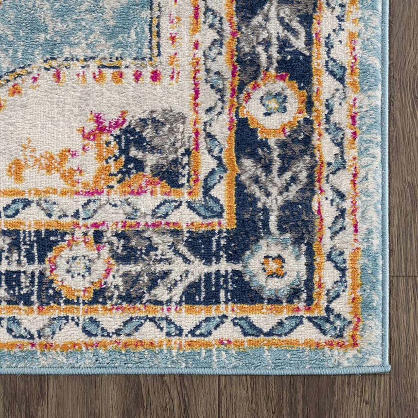 Close-up of the Tigried Turquoise 2308 rug, showcasing its blue, ivory, and orange bohemian-style pattern. Corner
