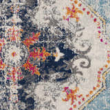 Close-up of the Tigried Turquoise 2308 rug. Features blue, ivory, and turquoise colors with a bohemian-inspired pattern. Corner