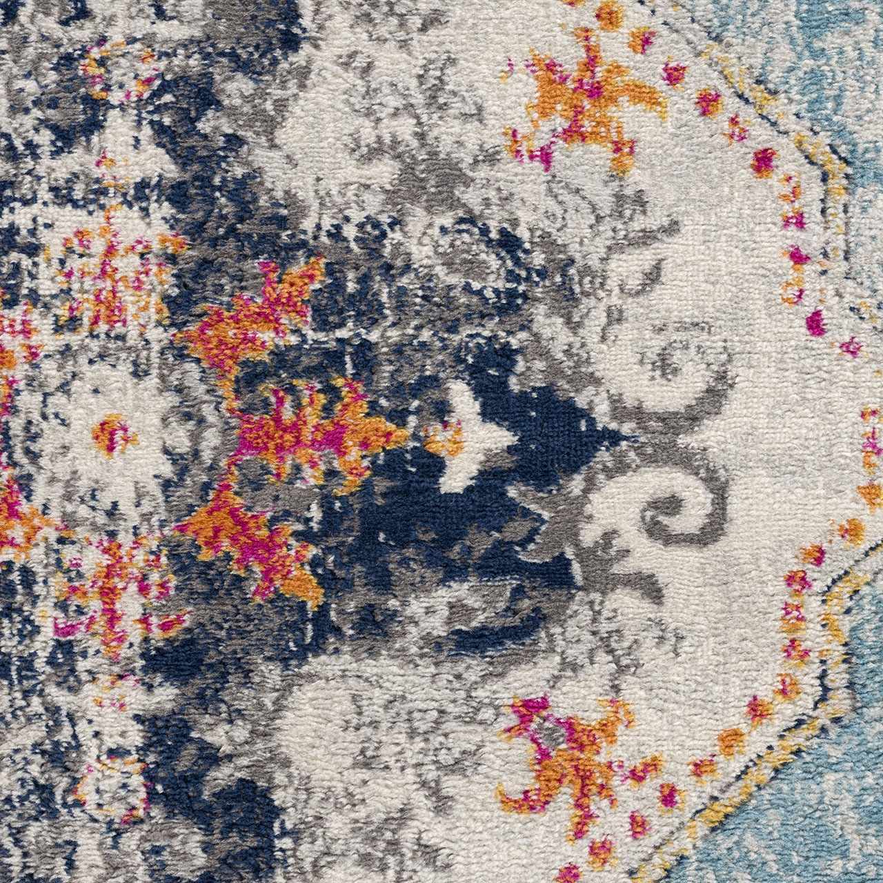 Close-up of the Tigried Turquoise 2308 rug. Features blue, ivory, and turquoise colors with a bohemian-inspired pattern. Corner