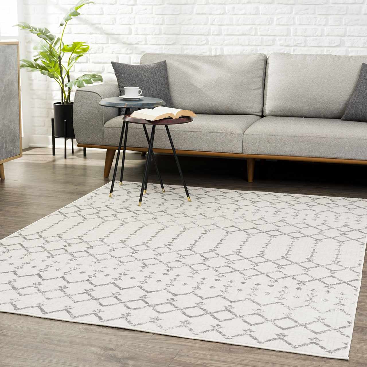 Living room scene with gray sofa and the ivory Tigri Aztec 2310 rug featuring a geometric pattern. Roomscene-Rectangle