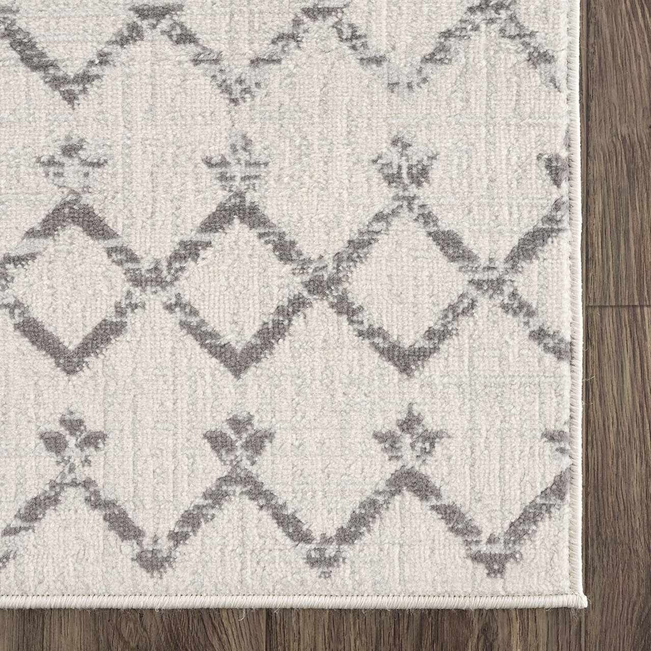 Close-up of Tigri Aztec 2310 Ivory Rug. Gray Aztec pattern on an ivory, machine-made polypropylene rug. Swatch