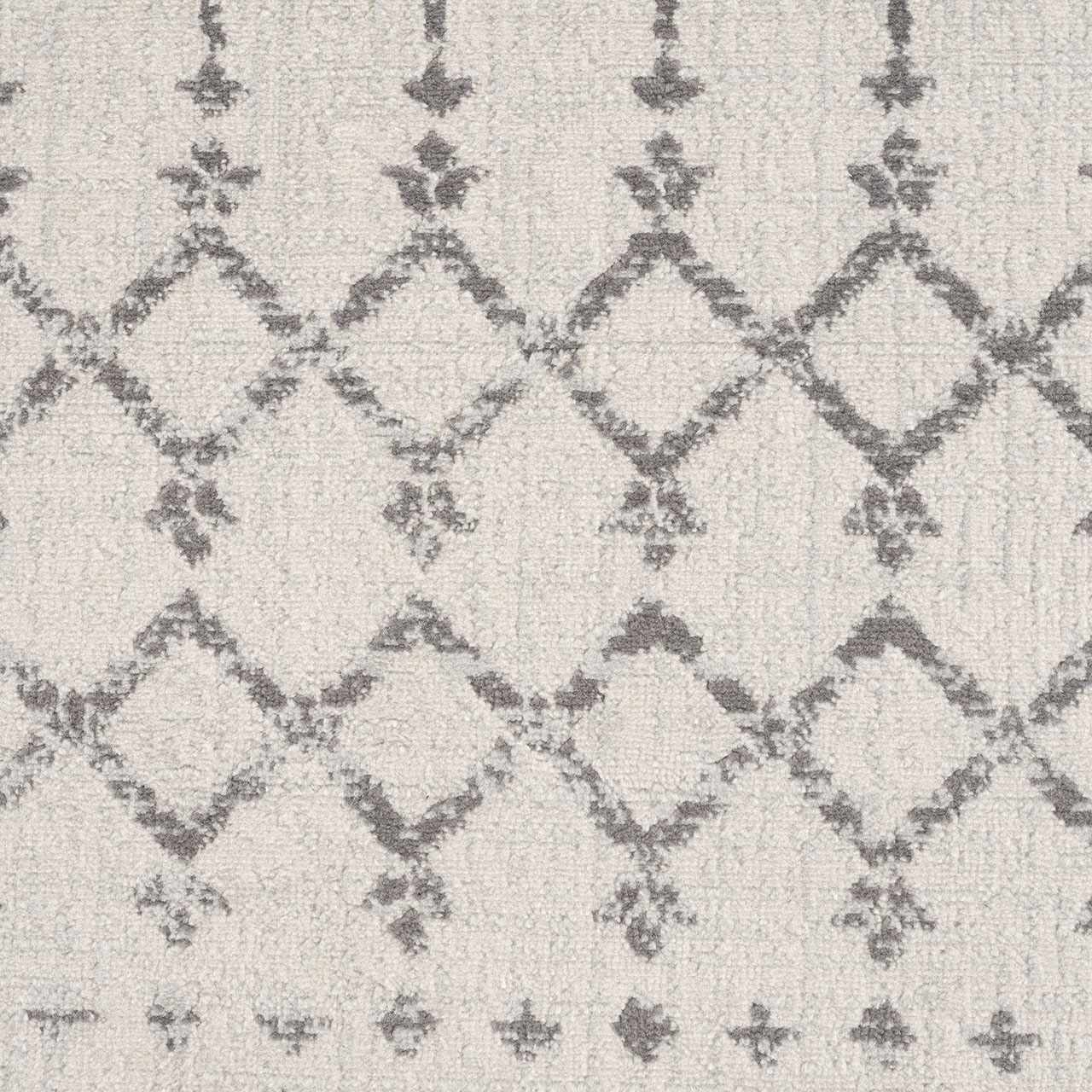 Close-up of Tigri Aztec 2310 Ivory Rug. Gray diamond and floral pattern on an ivory, textured, polypropylene rug. Texture