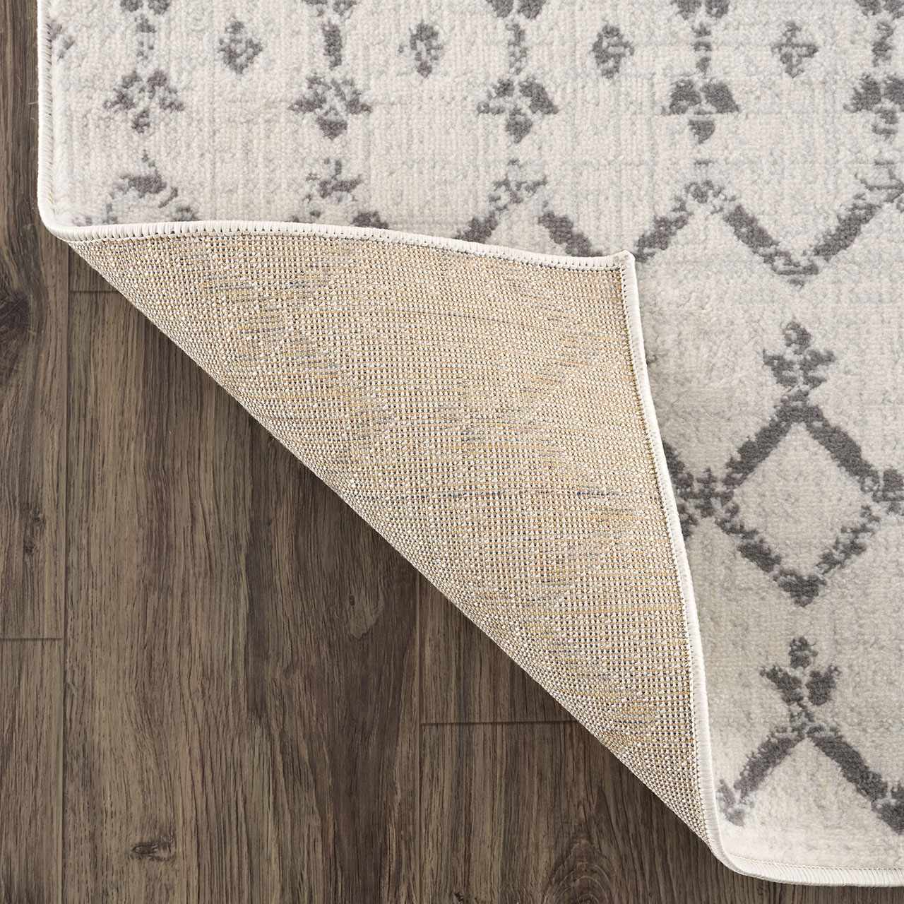Close-up of the Tigri Aztec 2310 Ivory Rug showing its gray Aztec pattern, ivory color, and durable backing. Fold