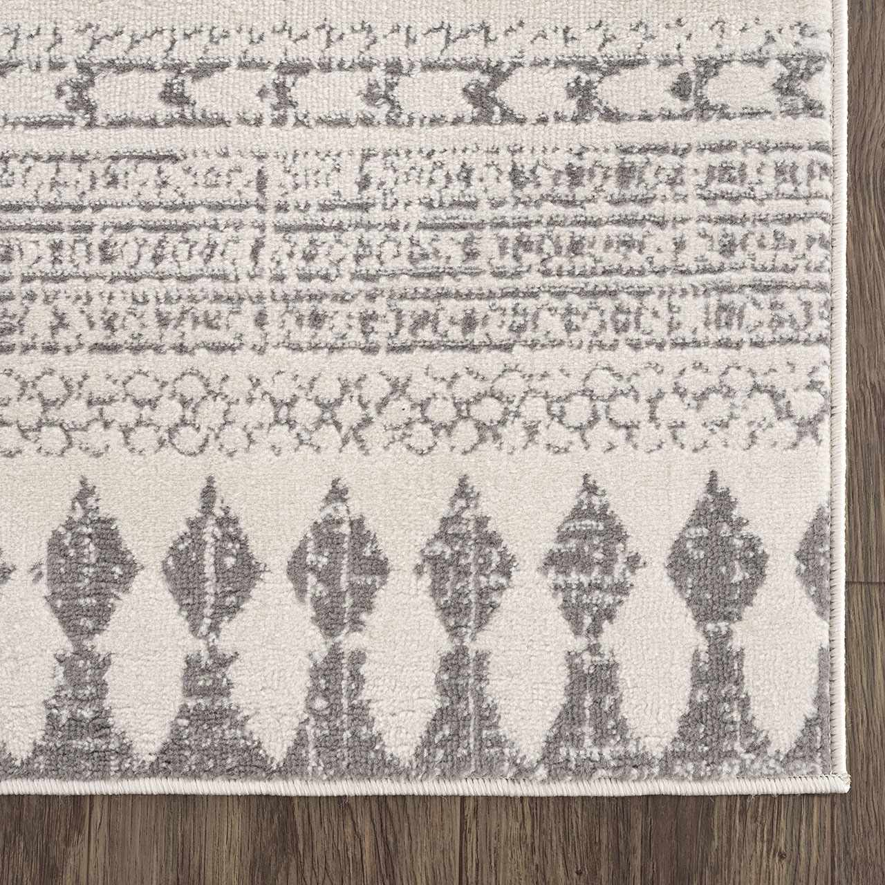 Close-up of Tigri Aztec Ivory & Gray 2311 Rug showing its gray geometric, diamond, and tribal-inspired pattern. Swatch