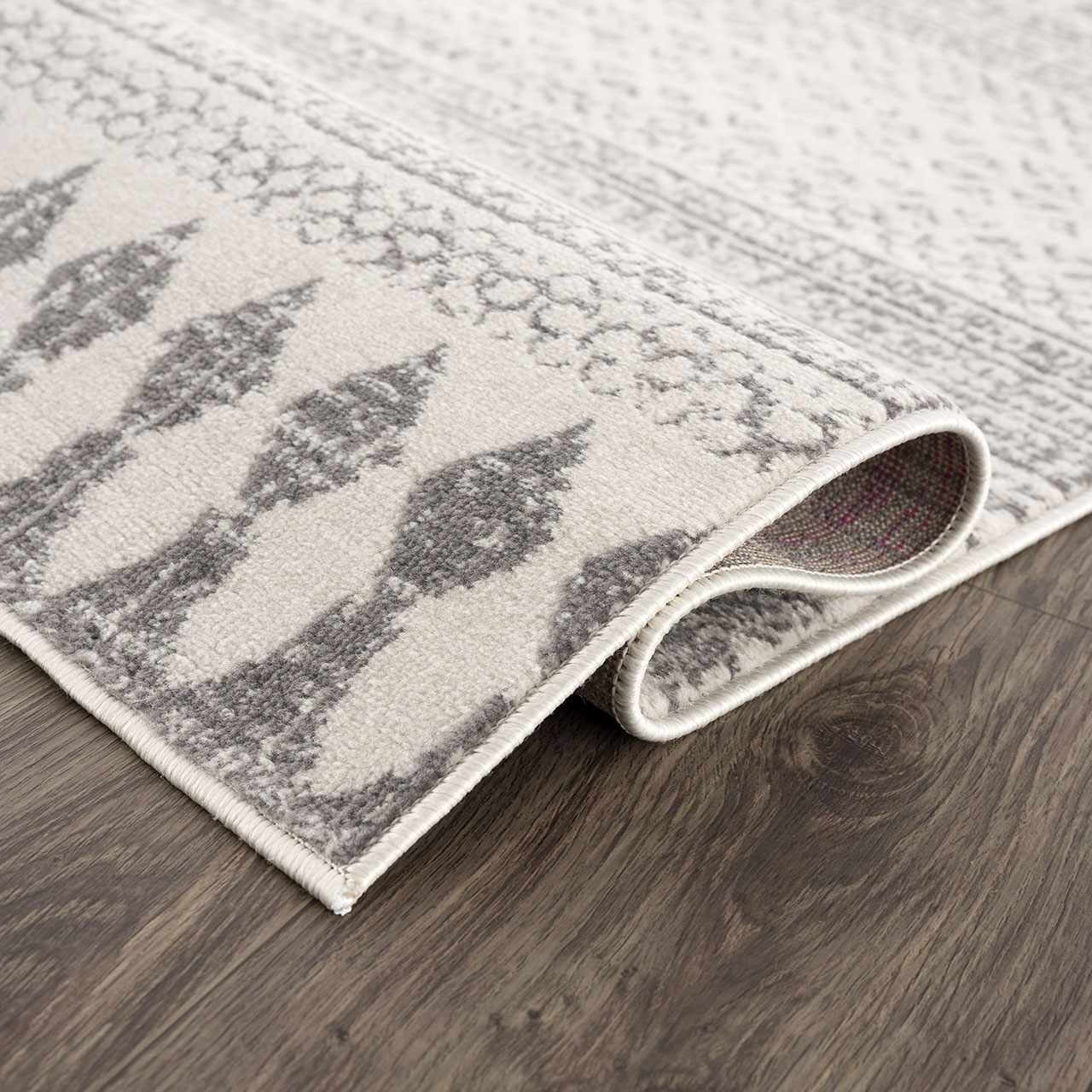 Close-up of Tigri Aztec Ivory & Gray 2311 Rug showing gray diamond pattern, ivory background, and machine-made construction. Fold