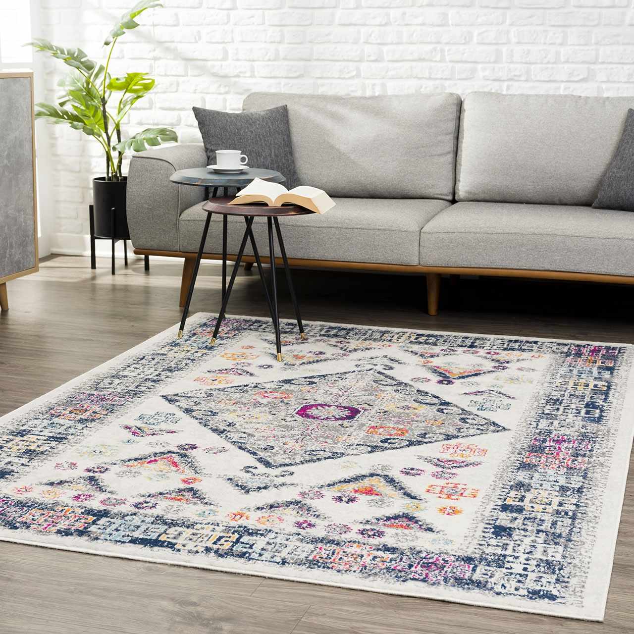 Living room scene with gray sofa and Tigriv Ivory 2312 rug. Bohemian style rug in ivory, navy, gray, and orange. Roomscene-Rectangle