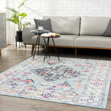 Living room scene with a Tigris Turquoise 2314 area rug, gray sofa, side tables, and a plant against a white brick wall. Roomscene-Rectangle